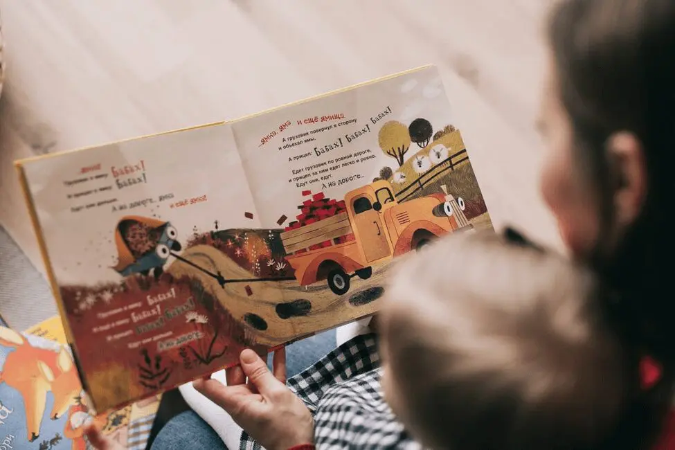 A child reading a storybook at daycare
