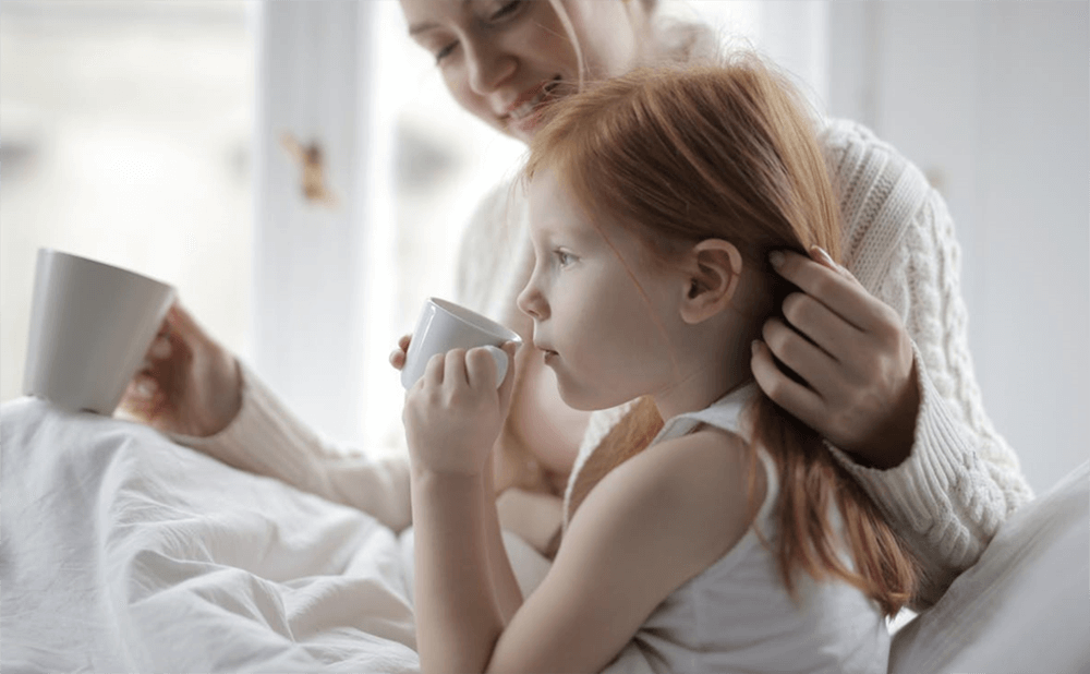 Mother and Daugther Holding Mugs