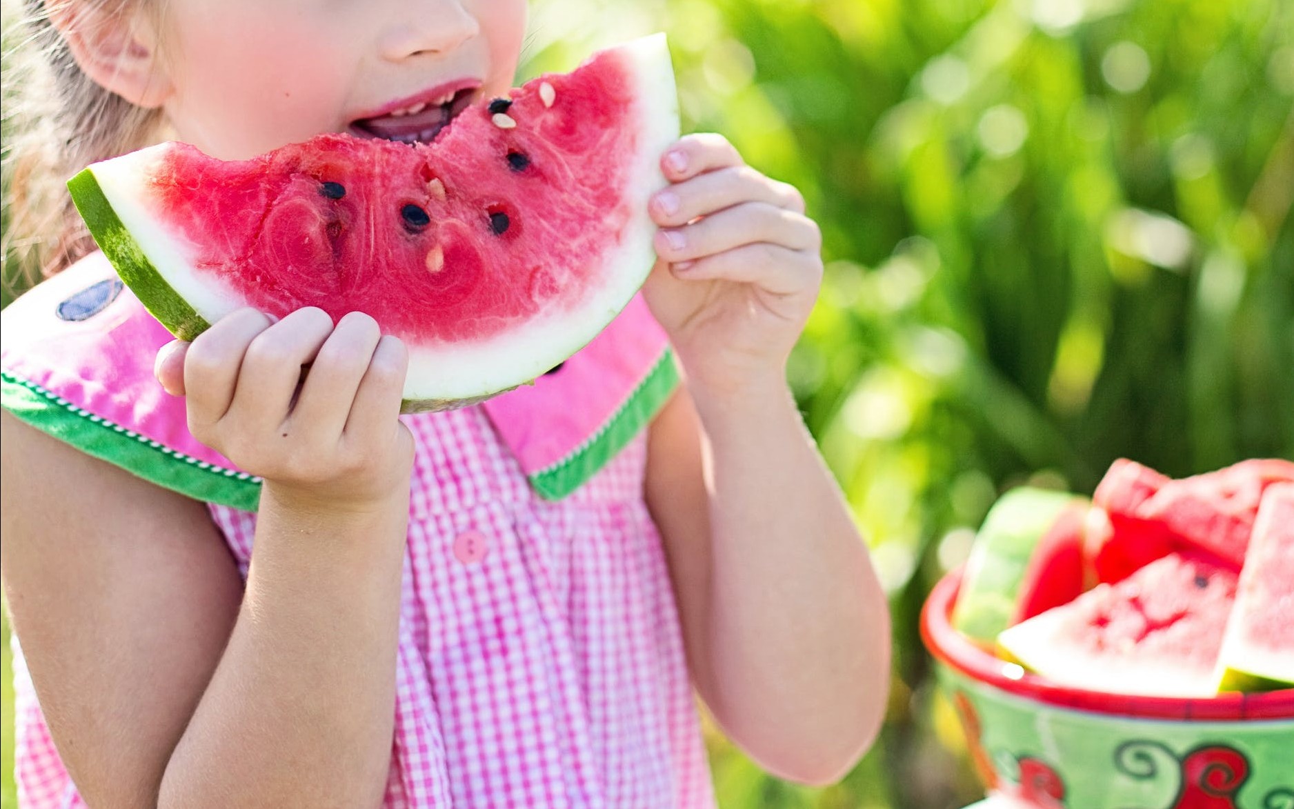 Young Girl Enjoying a Watermelon Slice