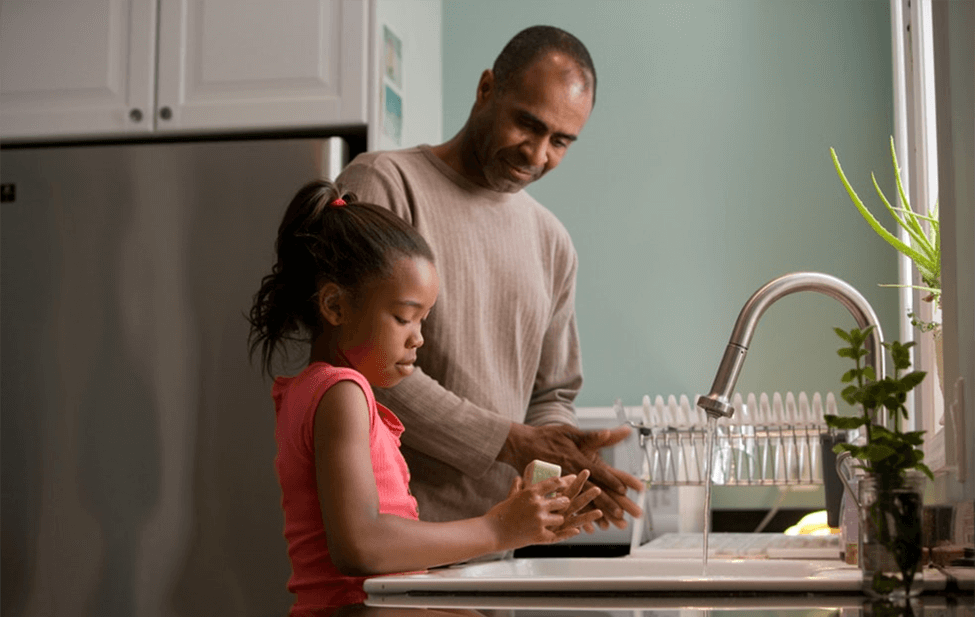 Father Helping Daughter Wash Hands