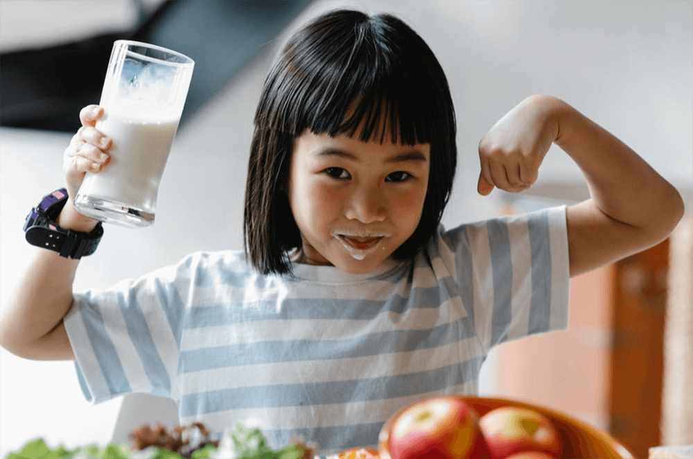 Girl Happily Drinking Milk